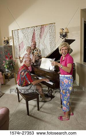 Senior man playing piano while friends enjoying View Large Photo Image Stock Image - Senior man playing piano while friends enjoying. Fotosearch