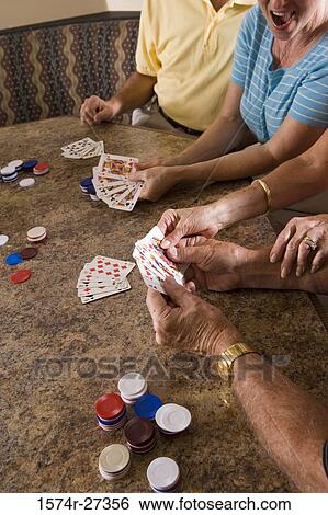 Senior men and women playing poker View Large Photo Image Stock Photograph - Senior men and women playing poker. Fotosearch