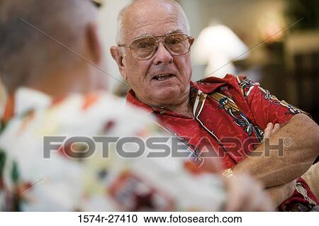 Stock Image - Senior men sitting together and discussing. Fotosearch