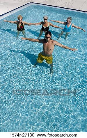 Senior women and young man exercising in swimming pool View Large Photo Image Stock Image - Senior women and young man exercising in swimming pool. Fotosearch