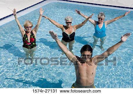 Senior women and young man exercising in swimming pool View Large Photo Image Stock Image - Senior women and young man exercising in swimming pool. Fotosearch