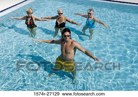 Senior women and young man exercising in swimming pool View Large Photo Image Stock Photo - Senior women and young man exercising in swimming pool. Fotosearch