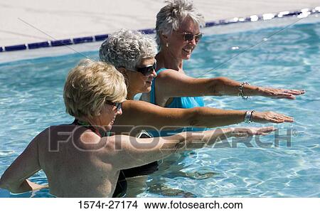 Senior women exercising in swimming pool View Large Photo Image Picture - Senior women exercising in swimming pool. Fotosearch
