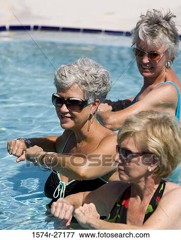 Senior women exercising in swimming pool View Large Photo Image Stock Photo - Senior women exercising in swimming pool. Fotosearch