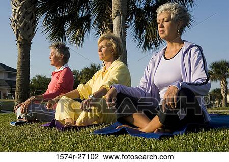 Senior women sitting on exercise mat and meditating View Large Photo Image Stock Image - Senior women sitting on exercise mat and meditating. Fotosearch