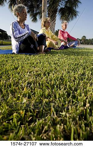 Senior women sitting on exercise mat and meditating View Large Photo Image Stock Photo - Senior women sitting on exercise mat and meditating. Fotosearch