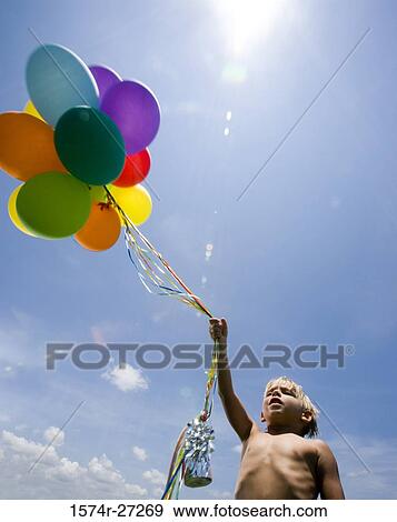 Stock Photo - Shirtless boy holding balloons. Fotosearch