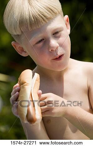 Shirtless boy holding hotdog View Large Photo Image Stock Image - Shirtless boy holding hotdog. Fotosearch