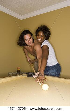 Shirtless young man playing pool with his girlfriend View Large Photo Image Picture - Shirtless young man playing pool with his girlfriend. Fotosearch