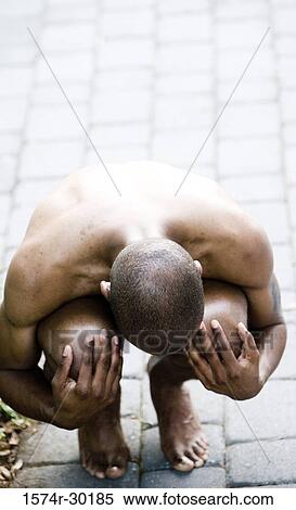 Shirtless young man sitting on the floor and hugging his knees View Large Photo Image Stock Photography - Shirtless young man sitting on the floor and hugging his knees. Fotosearch