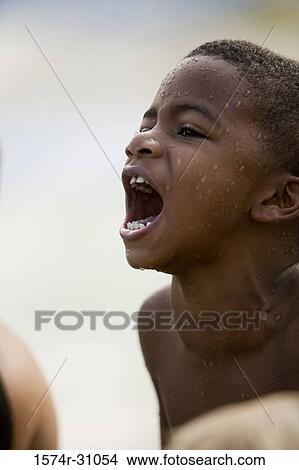 Picture - Side view of a boy shouting. Fotosearch
