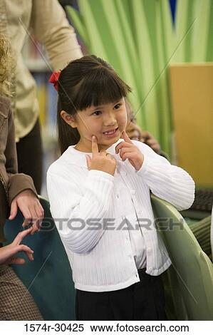 Side view of a girl gesturing View Large Photo Image Stock Photography - Side view of a girl gesturing. Fotosearch