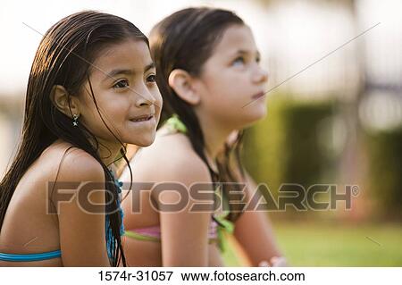 Side view of a girl looking away View Large Photo Image Stock Photo - Side view of a girl looking away. Fotosearch