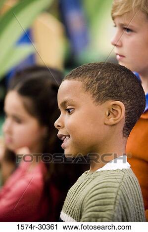 Stock Image - Side view of a schoolboy in pullover. Fotosearch