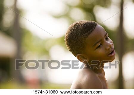 Side view of a shirtless boy looking away View Large Photo Image Stock Image - Side view of a shirtless boy looking away. Fotosearch