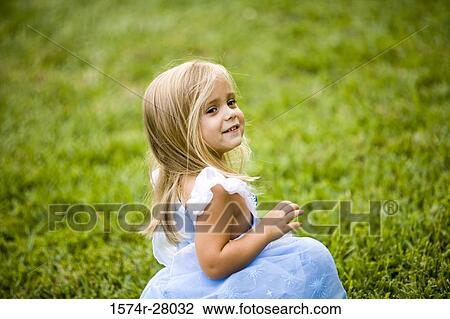 Side view of a smiling girl looking over shoulder View Large Photo Image Stock Image - Side view of a smiling girl looking over shoulder. Fotosearch
