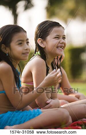 Side view of cheerful girls View Large Photo Image Stock Photo - Side view of cheerful girls. Fotosearch