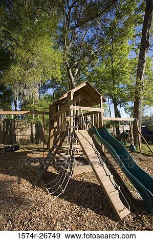 Stock Photo - Slide with jungle gym at forest. Fotosearch