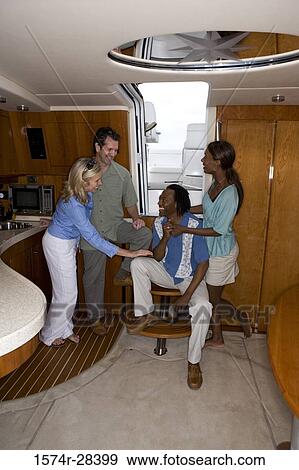 Smiling mid adult couples enjoying in the boat View Large Photo Image Stock Photo - Smiling mid adult couples enjoying in the boat. Fotosearch