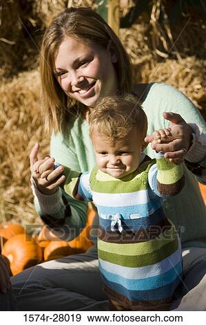 Stock Photo - Smiling mother and son holding hands. Fotosearch
