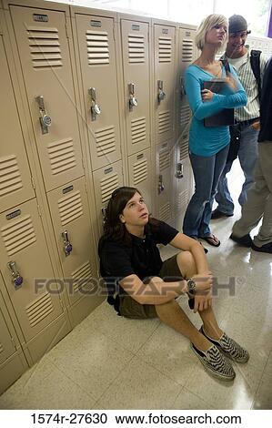 Stock Image - Students by lockers in corridor. Fotosearch
