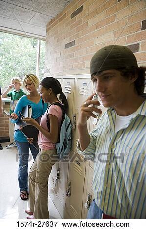 Students communicating and text messaging on mobile phone View Large Photo Image Stock Photo - Students communicating and text messaging on mobile phone. Fotosearch
