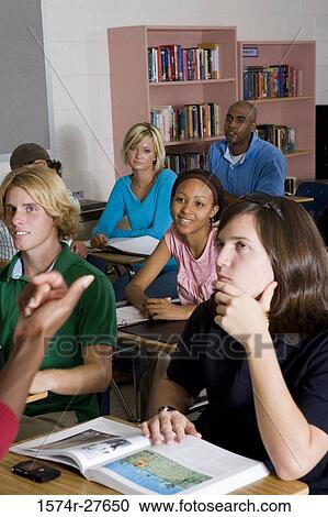 Students sitting and listening in the classroom View Large Photo Image Stock Image - Students sitting and listening in the classroom. Fotosearch
