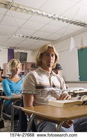 Students sitting in the classroom and reading book View Large Photo Image Stock Photo - Students sitting in the classroom and reading book. Fotosearch