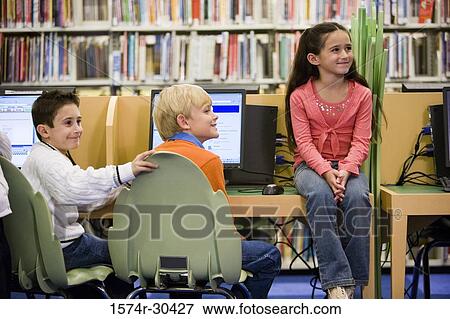 Students smiling and looking away in the library View Large Photo Image Stock Photo - Students smiling and looking away in the library. Fotosearch