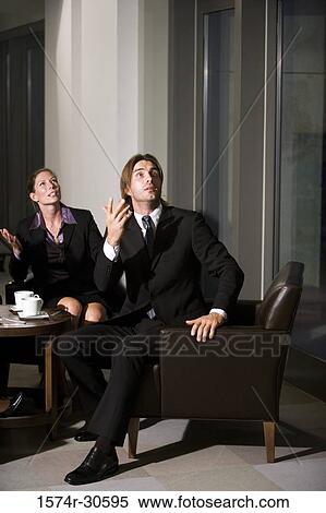 Surprised business people gesturing and looking up View Large Photo Image Stock Photography - Surprised business people gesturing and looking up. Fotosearch