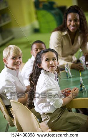 Teacher having refreshment with students in the library View Large Photo Image Stock Photo - Teacher having refreshment with students in the library. Fotosearch