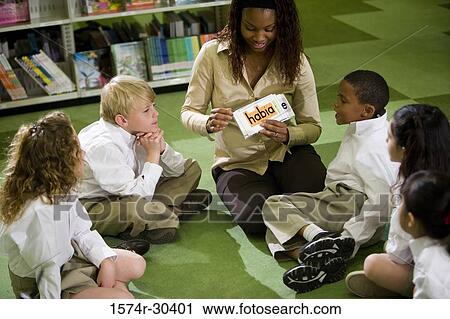 Teacher teaching students in the library View Large Photo Image Stock Image - Teacher teaching students in the library. Fotosearch