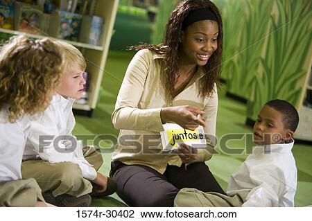 Teacher teaching students in the library View Large Photo Image Stock Image - Teacher teaching students in the library. Fotosearch