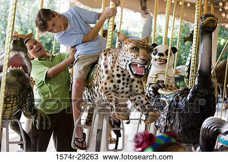 Teenage boys sitting on a carousel leopard View Large Photo Image Stock Image - Teenage boys sitting on a carousel leopard. Fotosearch