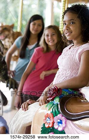 Teenage girl looking away with friends smiling in the background View Large Photo Image Stock Photo - Teenage girl looking away with friends smiling in the background. Fotosearch