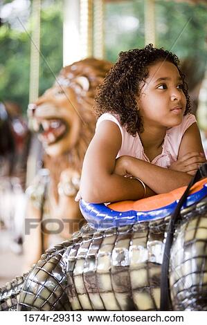 Teenage girl standing in a carousel with her arms crossed View Large Photo Image Stock Image - Teenage girl standing in a carousel with her arms crossed. Fotosearch