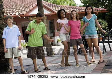 Teenagers dancing under the palm tree with house in the background View Large Photo Image Stock Image - Teenagers dancing under the palm tree with house in the background. Fotosearch