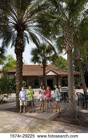 Teenagers dancing under the palm tree with a house in background View Large Photo Image Stock Photography - Teenagers dancing under the palm tree with a house in background. Fotosearch