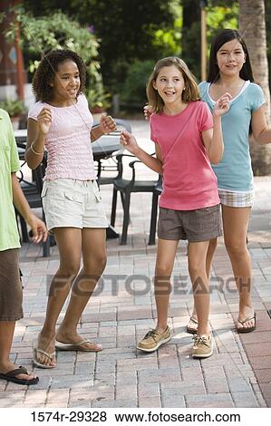 Teenagers dancing with chairs in the background View Large Photo Image Stock Photo - Teenagers dancing with chairs in the background. Fotosearch