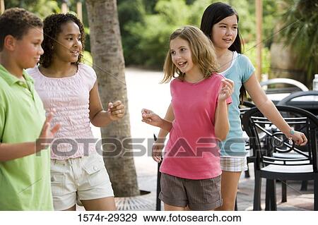 Teenagers dancing with chairs in the background View Large Photo Image Stock Photo - Teenagers dancing with chairs in the background. Fotosearch
