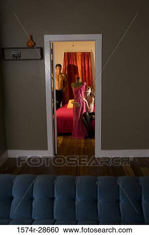 Topless young prostitute holding a mannequin in the bedroom while a mid adult man standing by bed View Large Photo Image Stock Image - Topless young prostitute holding a mannequin in the bedroom while a mid adult man standing by bed. Fotosearch