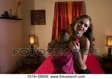 Topless young prostitute holding a mannequin in the bedroom View Large Photo Image Stock Photograph - Topless young prostitute holding a mannequin in the bedroom. Fotosearch