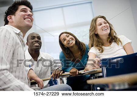 University students attending lecture in the classroom and smiling View Large Photo Image Stock Photo - University students attending lecture in the classroom and smiling. Fotosearch