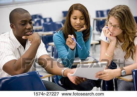 University students discussing with a book in the classroom View Large Photo Image Stock Photo - University students discussing with a book in the classroom. Fotosearch