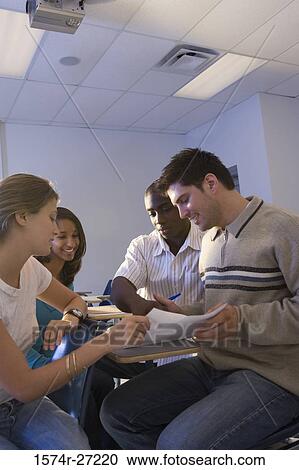 University students looking at a book in the classroom View Large Photo Image Stock Image - University students looking at a book in the classroom. Fotosearch