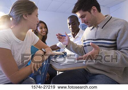 University students looking at a book in the classroom View Large Photo Image Stock Photo - University students looking at a book in the classroom. Fotosearch