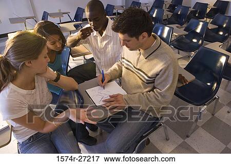 University students watching young man draw in a book in the classroom View Large Photo Image Stock Photo - University students watching young man draw in a book in the classroom. Fotosearch