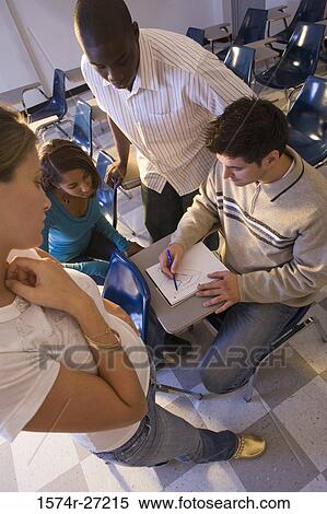 University students watching young man draw in a book in the classroom View Large Photo Image Stock Photography - University students watching young man draw in a book in the classroom. Fotosearch