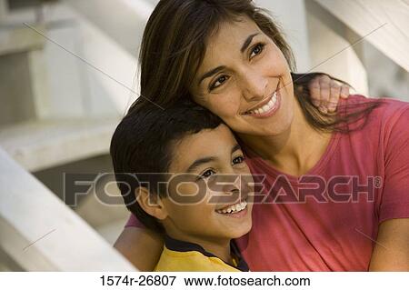 View of a mother embracing her son on staircase View Large Photo Image Stock Photo - View of a mother embracing her son on staircase. Fotosearch