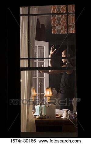 View of a window with a man standing in the background View Large Photo Image Stock Photograph - View of a window with a man standing in the background. Fotosearch